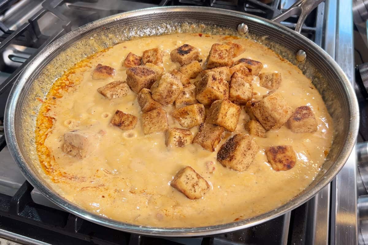 adding tofu to skillet