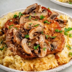 a plate filled with mashed potatoe and tofu marsala